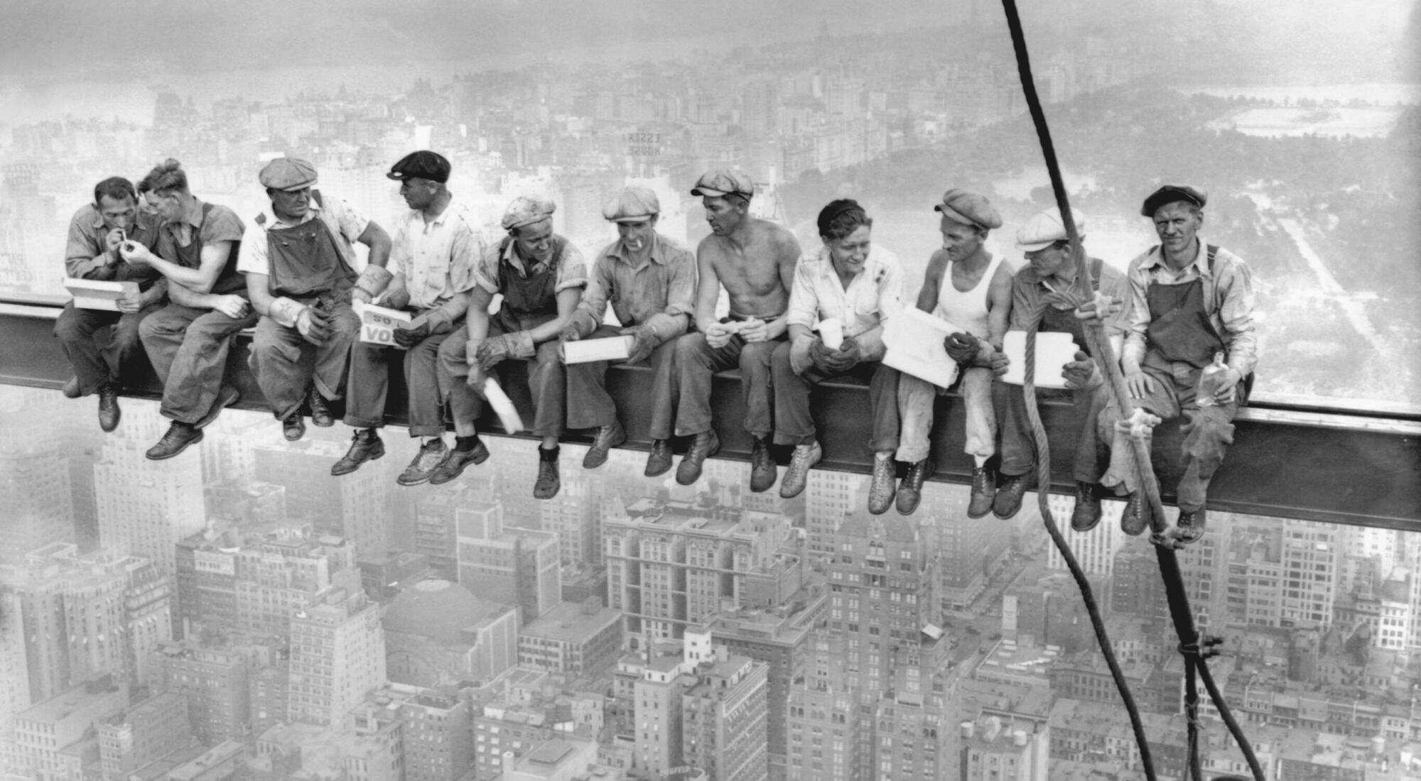 Lunch atop a Skyscraper: eleven ironworkers eating lunch on a steel beam high above New York City, 1932