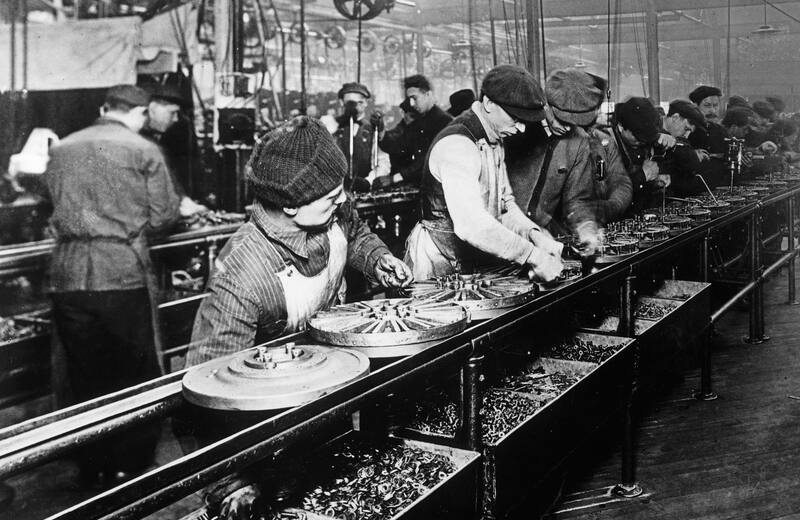 Workers on the Ford Motor Company assembly line in 1913